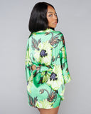 Silk kimono robe from Klements showcases a floral pattern in shades of green, black, orange, purple, and white