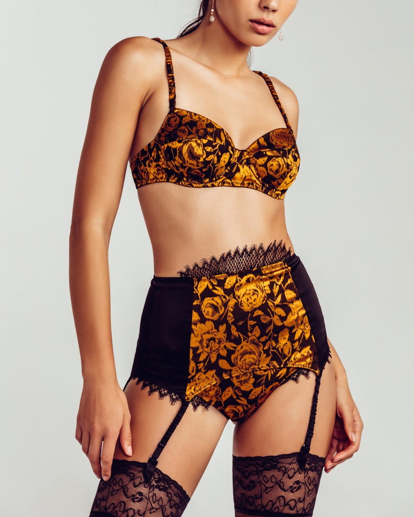 Longline silk garterbelt from Camille Roucher has gold floral silk at the front panel, with black silk at the sides and rear