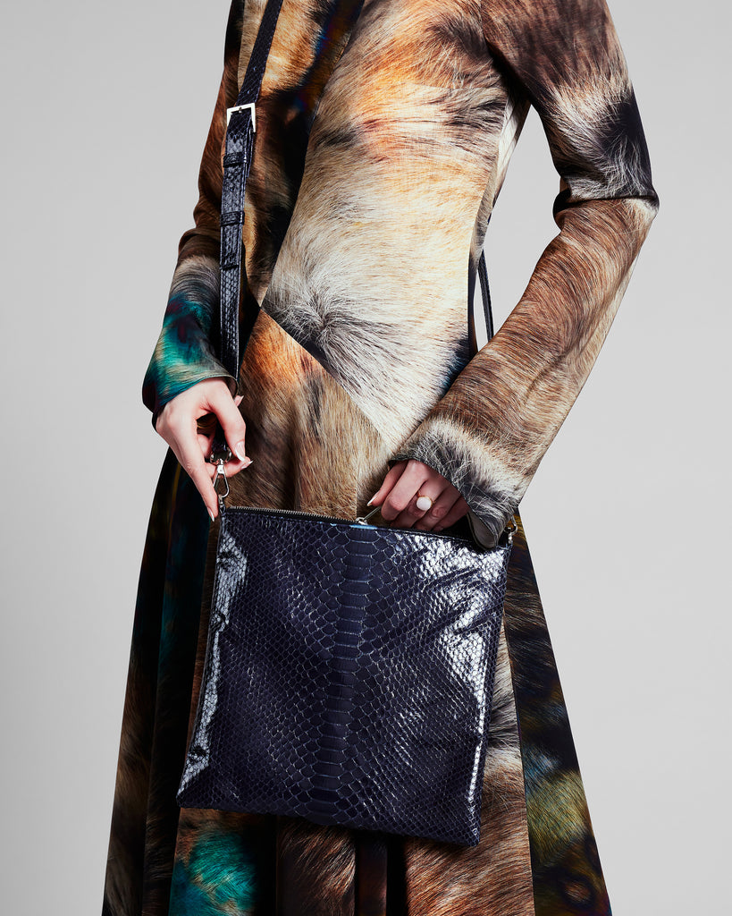 Cross-body purse from Elisabeth Weinstock is crafted from navy blue glazed snakeskin 