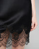 Black silk chemise from Emma Harris has shimmering scalloped floral black lace appliqué at the hem