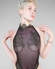 Black Orunée bodysuit from Hervé by Céline Marie is entirely transparent with golden lace appliqué across the bust, abdomen, and cut out at the decorative high neck