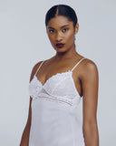 Affinite Couture White cotton slip is accented with Calais lace detailing at the bust and hem