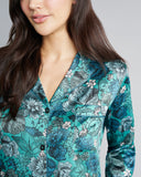 Classic Jardin de Nuit silk pajama from Morpho + Luna showcase a floral print in shades of teal, blue, green, gray and white
