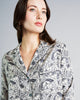 Classic silk pajamas from Morpho + Luna showcase a geometric butterfly print in heathered shades of black, grey, and ivory
