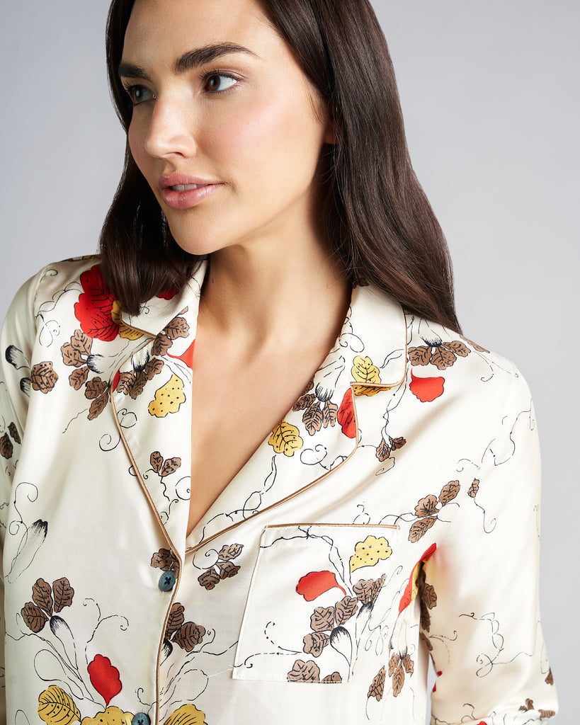 Button-down long sleeved shirt from Morpho + Luna features branded mother of pearl buttons, a chest pocket and curved notch lapels