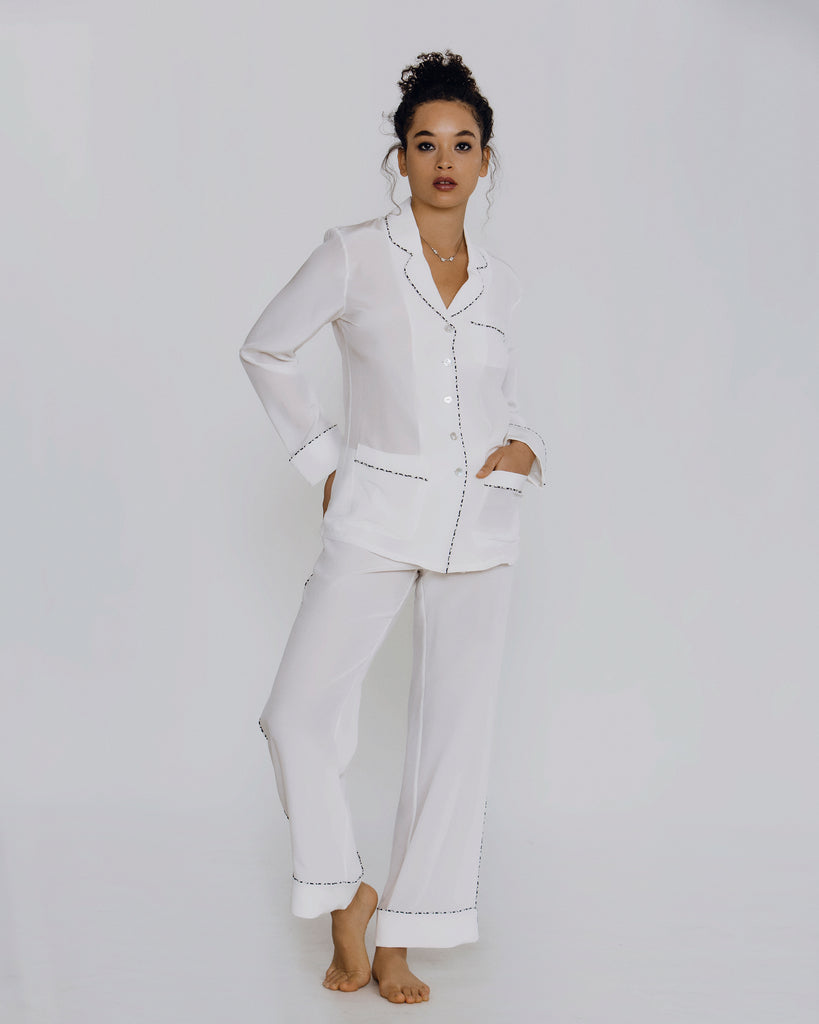 White silk crepe de chine pajama from Olivia Von Halle is lightweight and elegant, with navy patterned piping