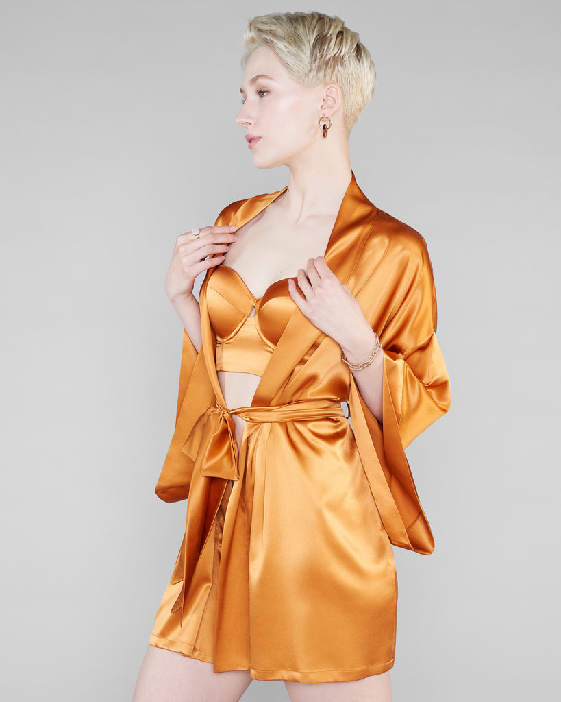 Classic short robe from Studio Pia is crafted from a golden amber peace silk