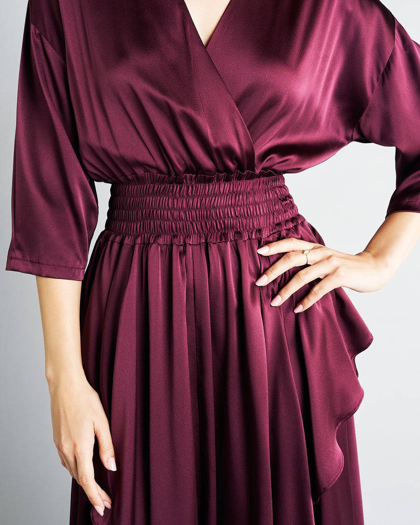 Vannina Vesperini's Schiap dress has 3/4 sleeves with a crossover deep v neckline and a shirred elasticized waist